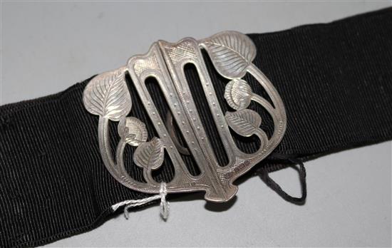 An Edwardian Art Nouveau silver belt buckle.